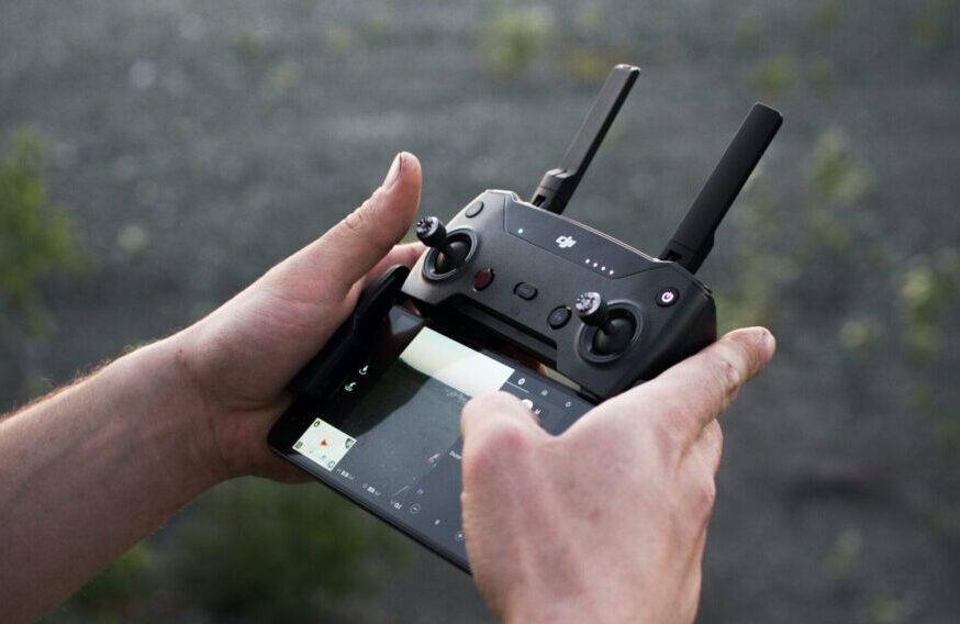 Hands holding a drone remote controller